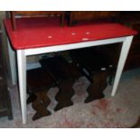A 3' 6" vintage red Formica topped kitchen table, set on white painted tapered legs