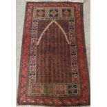 An old Middle Eastern wool prayer rug with mihrab on repeat ground and flanked by geometric panels