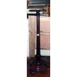 A late Victorian stained mahogany aspidistra stand with tapered turned pillar and circular