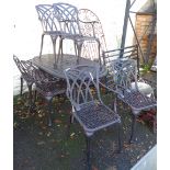 A cast aluminium garden table and six chairs - table length 5'