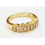 An import marked 750 gold ring with ten small diamonds in a meandering border - 0.28ct. TDW
