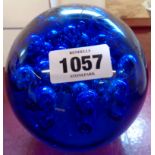 A large blue glass paperweight