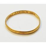An antique yellow metal ring inscribed internally "God above send peace and love" - dug up by the