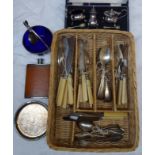 A wicker cutlery tray containing a cased silver plated three piece condiment set, plated cutlery,