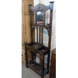 An early 20th Century stained oak hallstand with bevelled oblong mirror, four original hooks and