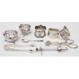 A pair of Chester silver salts, three silver napkin rings, sugar tongs and coffee spoon - sold
