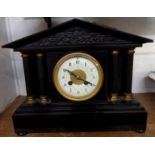 A late Victorian black slate cased mantel clock of architectural design with S. Marti eight day gong