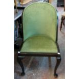 A 1930`s stained mixed wood tub-back occasional chair with green velour upholstery, set on