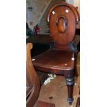 A Victorian mahogany stylised shield back hall chair with moulded seat, set on turned front legs