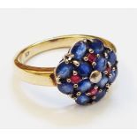 A marked 9ct. blue and red stone cluster ring