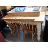 A 4' modern waxed pine topped kitchen table, set on a painted base with frieze drawer and turned