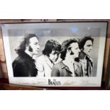 A framed large reproduction print of The Beatles with facsimile autographs under