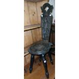 A late Victorian stained and carved oak spinning chair with pierced decorative back, seat panel