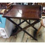 A reproduction brass bound mahogany butler's tray by The Bombay Company on folding stand