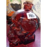 A red glass skull bottle