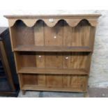 A 3' 7" wall mounted waxed elm three shelf open plate rack with moulded cornice, shaped frieze and
