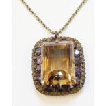An ornate white metal pierced panel pendant, set with central (40mm X 30mm) faceted smoky quartz