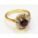 A marked 750 gold ring, set with ruby and diamond