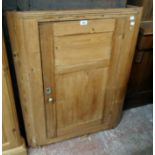 A 31 1/2" 19th Century waxed pine barrel back corner cabinet with scalloped shelves enclosed by a