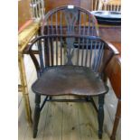 An antique yew Windsor elbow chair with double pierced splat back and moulded solid elm seat, set on