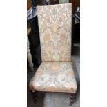 A Victorian prie dieu chair with later tapestry upholstery, set on turned front legs and casters