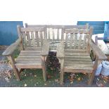 A teak garden bench and pair of matching elbow chairs