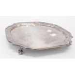 A 9" Edward Viner silver salver with cast shaped rim, set on stylised nautilus pattern feet -