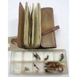 A vintage leather wallet wrap containing a collection of salmon and sea trout flies - sold with a