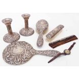 A six piece silver mounted dressing table set in the Victorian style with embossed scroll, mask
