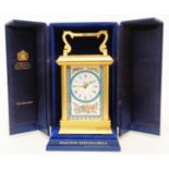 A Halcyon Days Enamels ornate gilt metal cased carriage timepiece with decorative dial and eight day