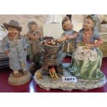 A Capodimonte figure group of chestnut vendors - sold with two figures of miserable looking
