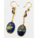 A pair of Egyptian Revival style yellow metal mounted ear-rings, each with carved scarab lapis