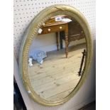 An old gilt framed bevelled oval wall mirror