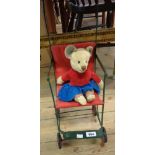 A vintage doll's pushchair and Teddy bear