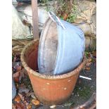 A large terracotta pot and a small galvanised bath