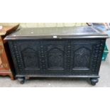 A 4' 2" dated "1939" polished and carved oak triple panel front coffer with profuse decoration and