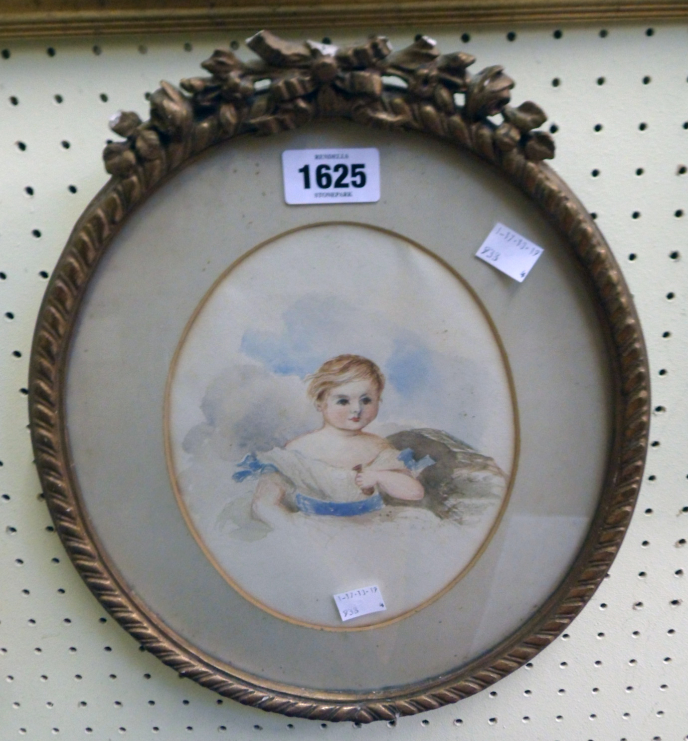 A gilt framed 19th Century oval watercolour portrait depicting a young girl, old label verso