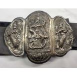 A vintage Hindu white metal nurse's type belt buckle depicting Lakshmi standing on a large snake -
