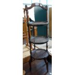 A 1920`s stained walnut three tier cake stand with rattan surfaces and slender square moulded