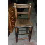 An antique beech and elm child's high chair with solid moulded seat and simple turned supports