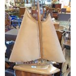 A vintage polished wood table lamp in the form of a yacht