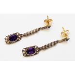 A pair of marked 750 bi-metal Edwardian style drop ear-rings each set with oval amethyst within an