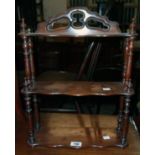 A 14 1/2" reproduction mahogany wall mounted three tier whatnot, with shaped surfaces and slender