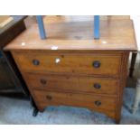 A 36" Edwardian walnut chest of three long drawers, set on bracketed and moulded supports