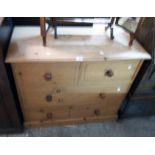 A 36" modern waxed pine chest of two short and two long drawers, set on plinth base
