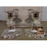 A boxed pair of 5" modern silver plated candlesticks in the Georgian style