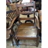 A late Georgian oak elbow chair with solid seat panel, turned front supports and deep apron