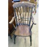 An antique stained mixed wood stick back elbow chair with solid moulded seat, set on ring turned