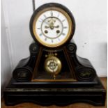 A late Victorian black slate and marble drum and scroll pedestal cased mantel clock with visible