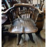 An early 20th Century stained mixed wood and painted iron framed swivel office chair with stick
